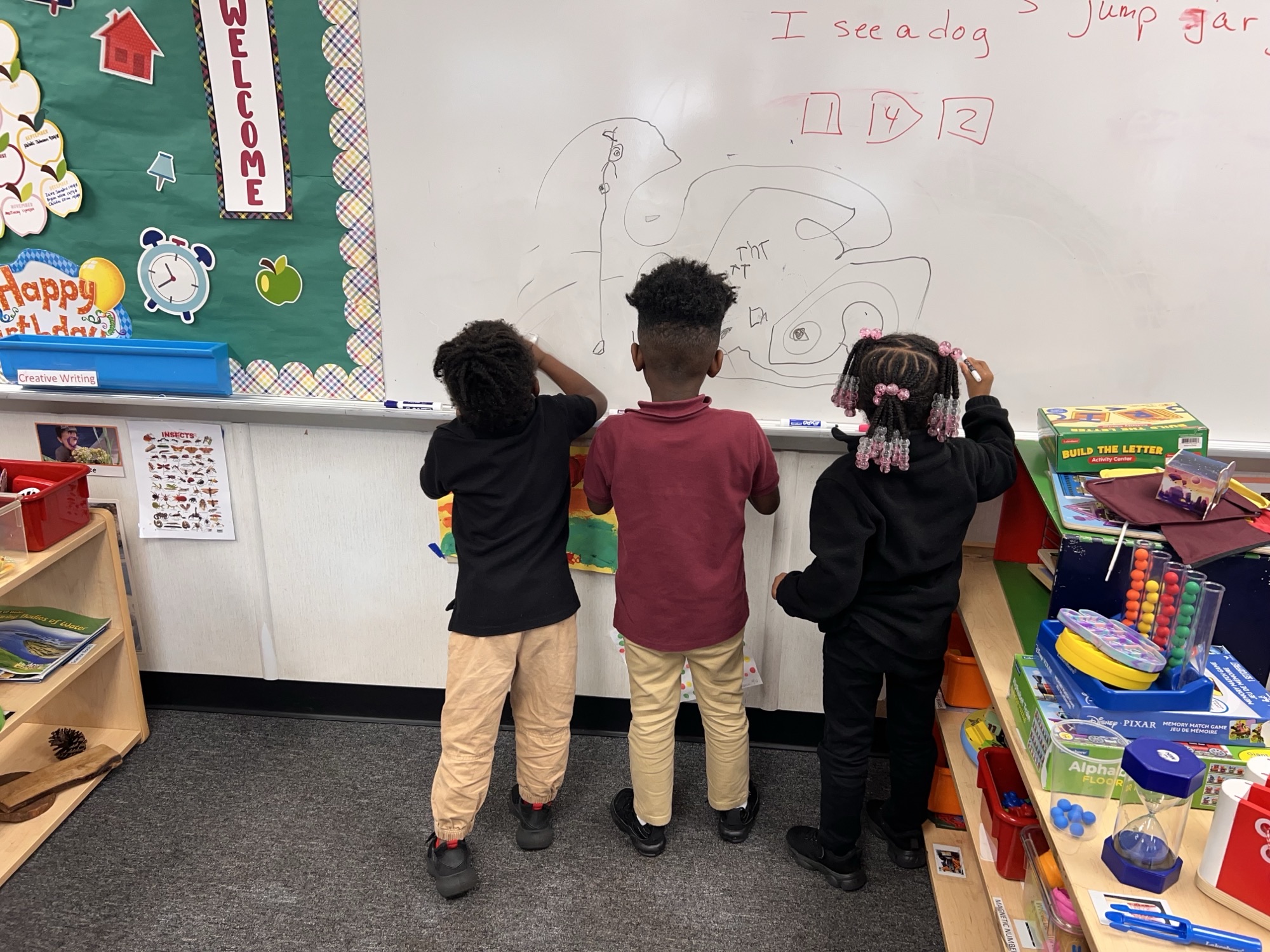 kids writing on a whiteboard